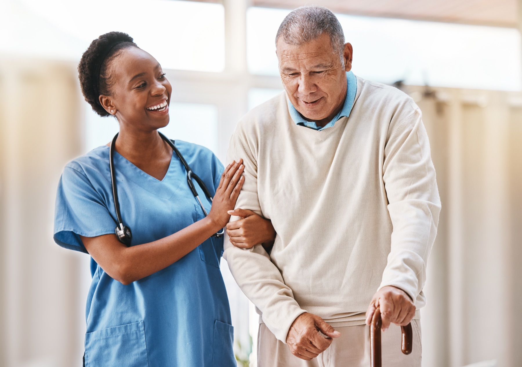 caregiver helping client with a coat or a walk
