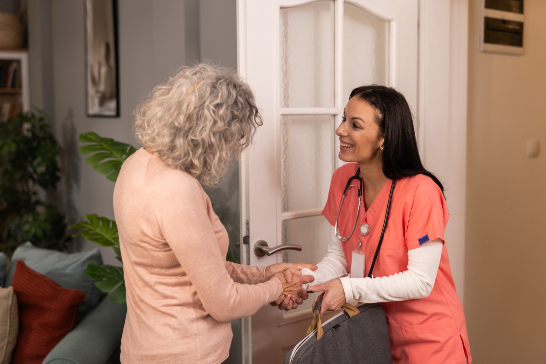 caregiver arriving at the door, warm greeting