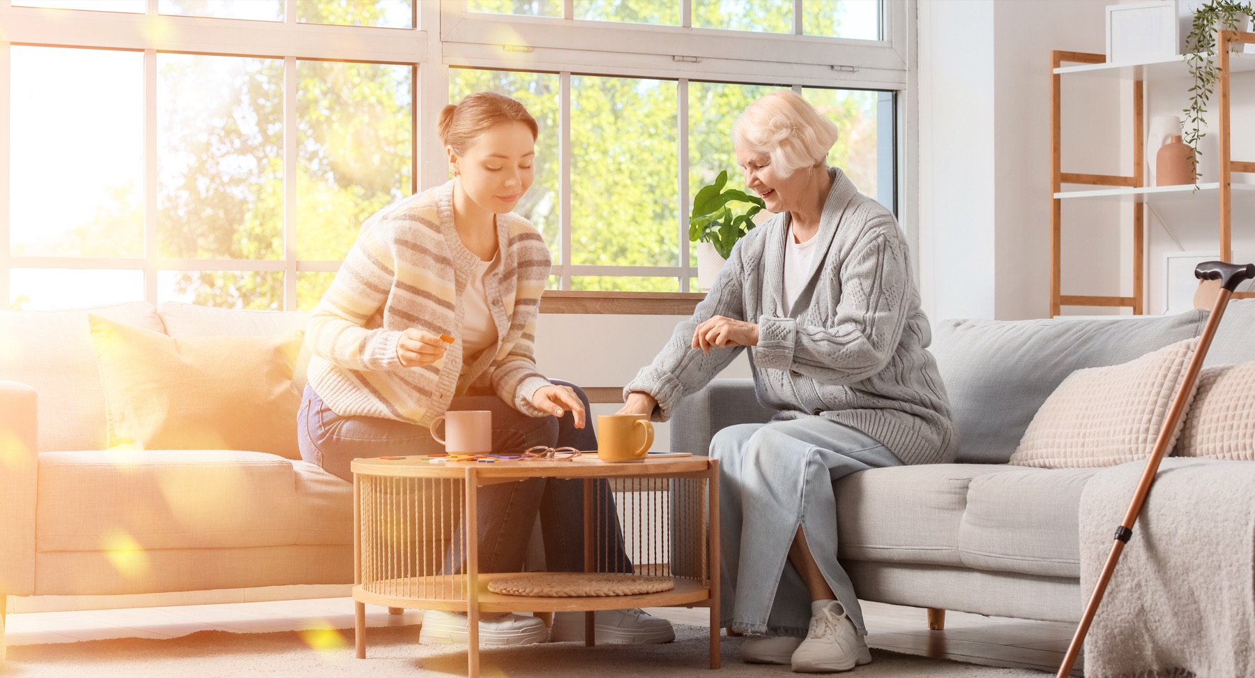 caregiver and older client at home, natural light